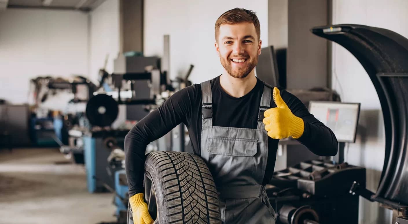 mechanic hold a tire